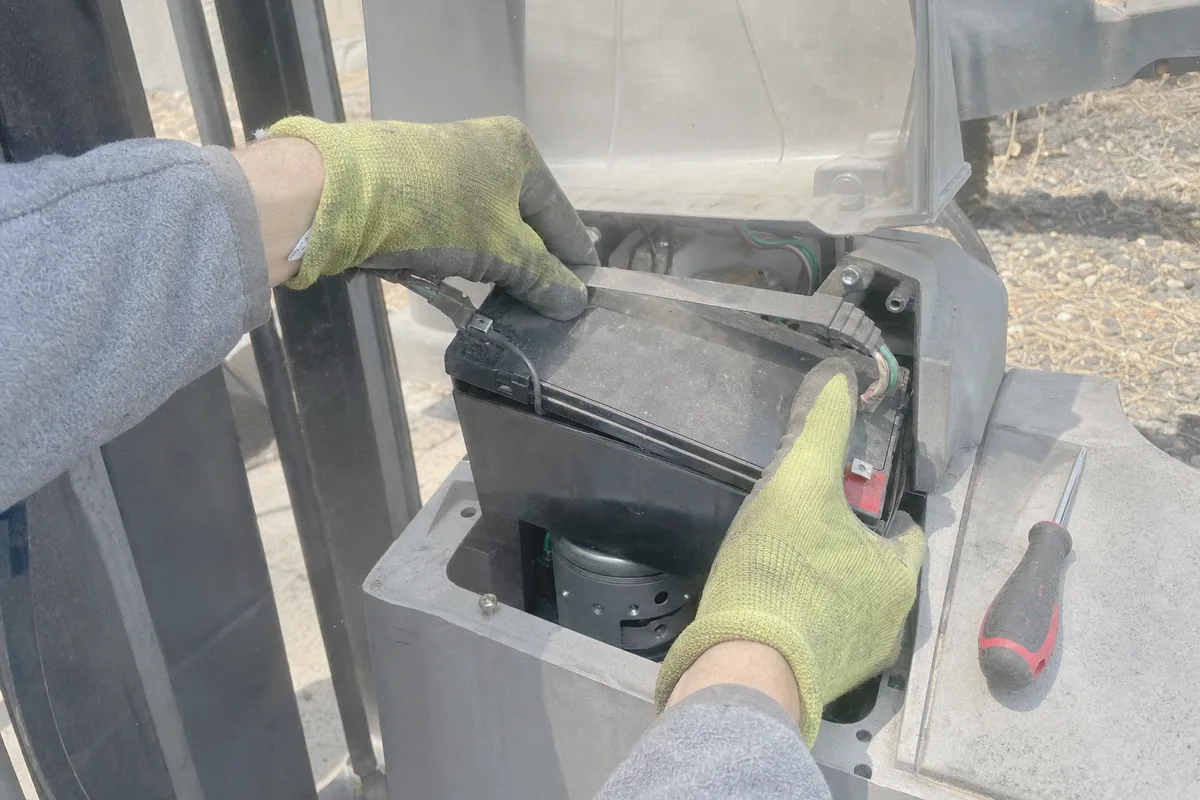 Close-up of gate opener repair work in progress